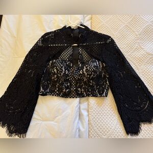 Bebe long sleeve lace top with lined bra inside for light support.